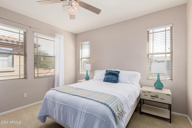 bedroom with carpet, multiple windows, and ceiling fan