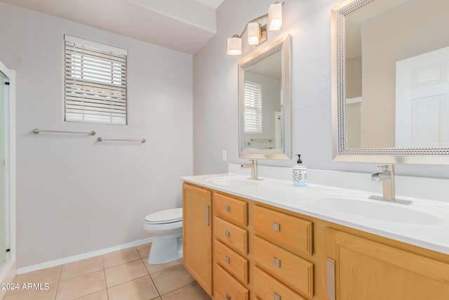 bathroom with dual vanity, tile flooring, and toilet