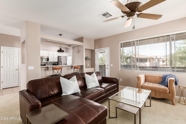 living room with light carpet and ceiling fan