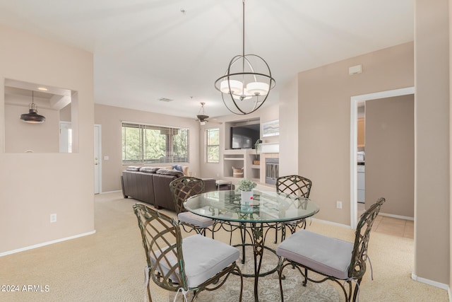 dining room featuring an inviting chandelier and light colored carpet