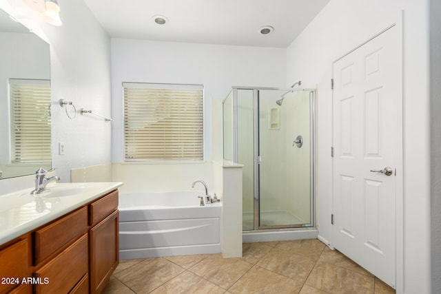 bathroom with tile patterned floors, vanity, and independent shower and bath