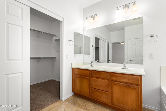 bathroom with tile patterned flooring, vanity, and ceiling fan