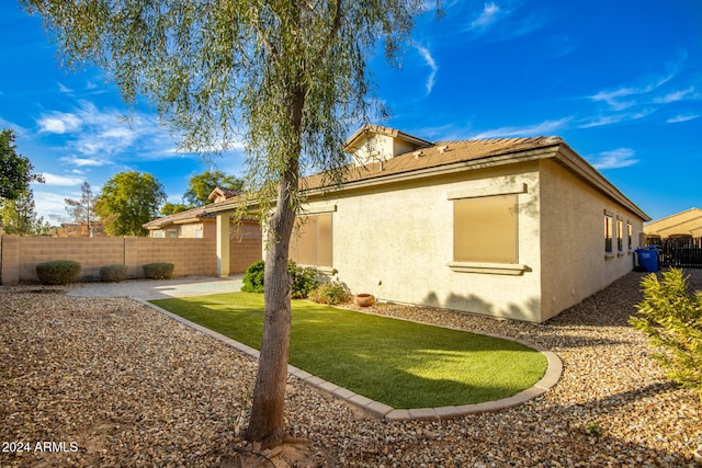 rear view of property with a lawn