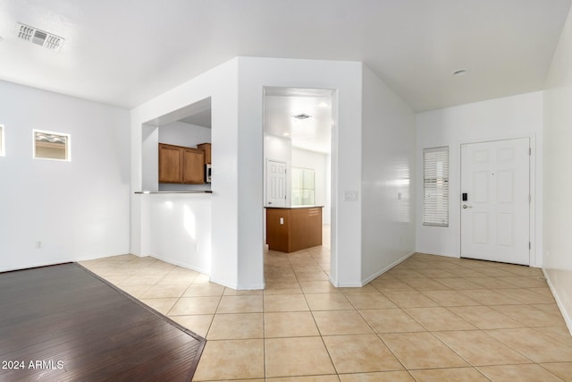 foyer entrance featuring light tile patterned flooring