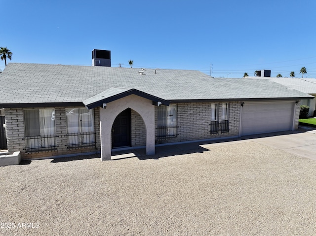 ranch-style house with driveway and a garage