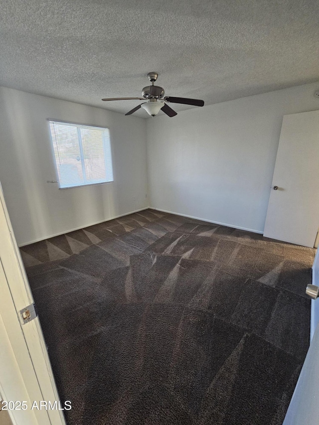 empty room featuring a textured ceiling, a ceiling fan, and carpet flooring