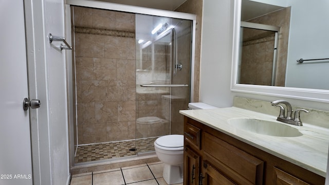 bathroom with a stall shower, tile patterned flooring, vanity, and toilet