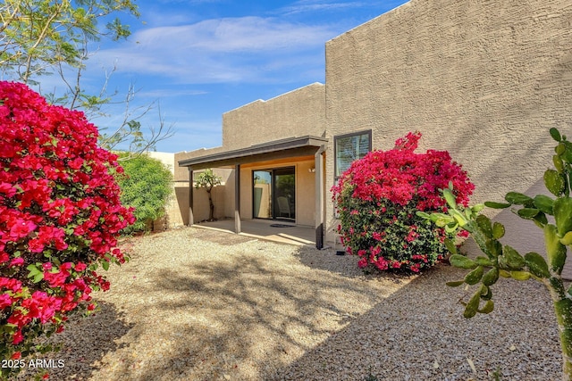 11775 E Becker Ln, Scottsdale, AZ 85259 - rear view of house featuring stucco siding and a patio area