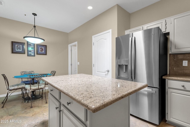 11775 E Becker Ln, Scottsdale, AZ 85259 - kitchen featuring stainless steel fridge, a kitchen island, backsplash, pendant lighting, and baseboards