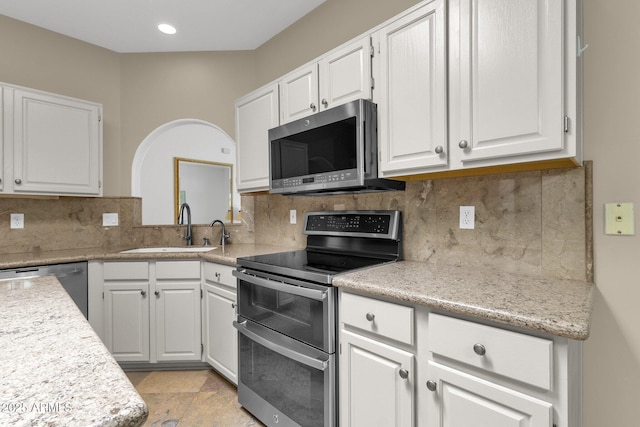 11775 E Becker Ln, Scottsdale, AZ 85259 - kitchen with stainless steel appliances, a sink, light countertops, white cabinetry, and backsplash