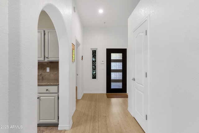 11775 E Becker Ln, Scottsdale, AZ 85259 - foyer with light wood-style floors, baseboards, and arched walkways