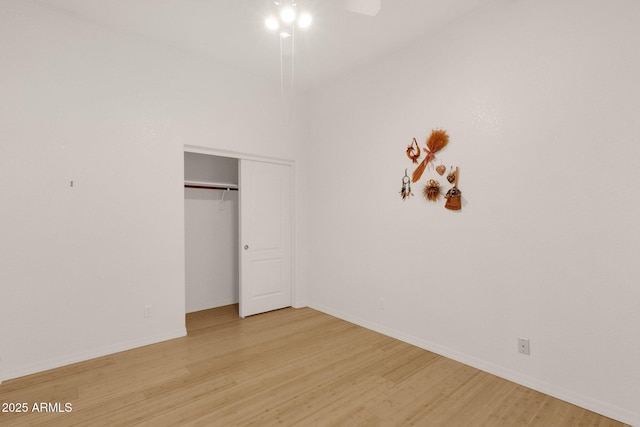 11775 E Becker Ln, Scottsdale, AZ 85259 - unfurnished bedroom featuring light wood finished floors, baseboards, a closet, and ceiling fan