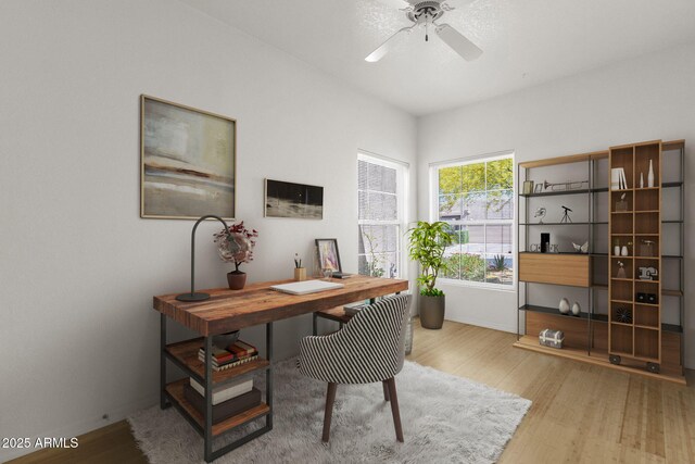 11775 E Becker Ln, Scottsdale, AZ 85259 - home office featuring wood finished floors, a ceiling fan, and baseboards
