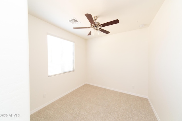 spare room with light colored carpet and ceiling fan