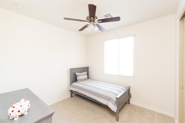 bedroom featuring light carpet and ceiling fan