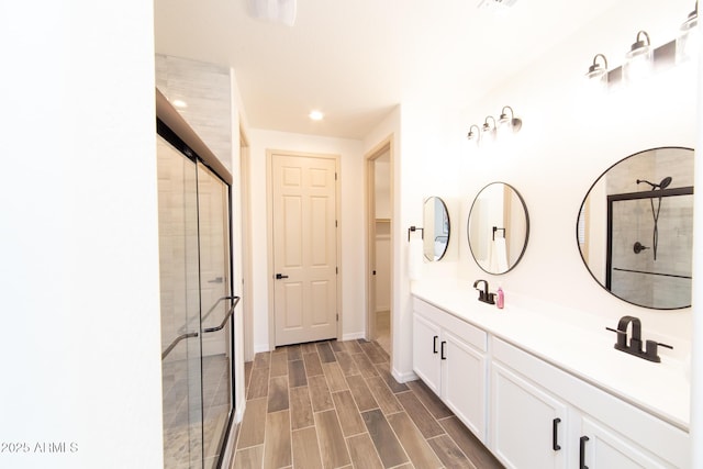 bathroom featuring vanity and a shower with shower door