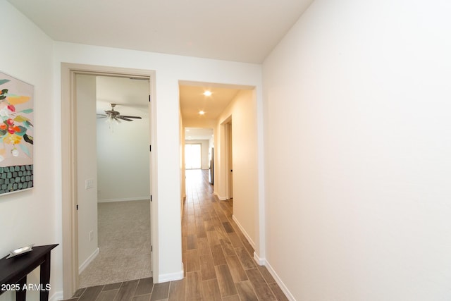 corridor with hardwood / wood-style floors