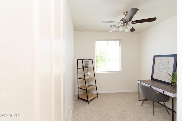 carpeted home office featuring ceiling fan