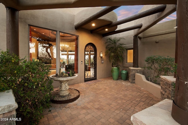 exterior entry at dusk with a patio area and french doors