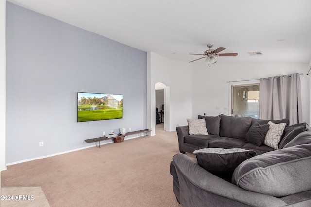 living room with ceiling fan, light carpet, and vaulted ceiling