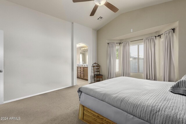 carpeted bedroom with ensuite bathroom, vaulted ceiling, and ceiling fan