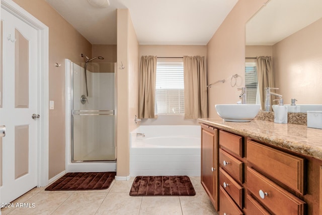 bathroom with tile patterned flooring, vanity, and shower with separate bathtub