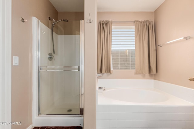 bathroom with shower with separate bathtub