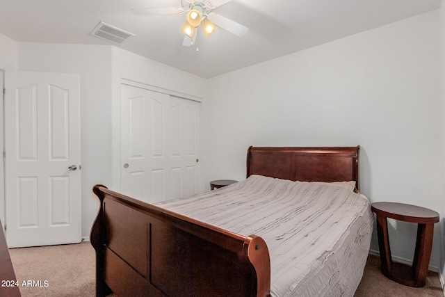 carpeted bedroom featuring ceiling fan and a closet