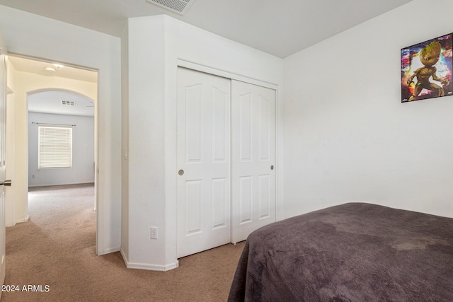 carpeted bedroom with a closet