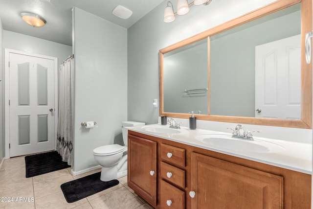 bathroom featuring tile patterned floors, vanity, and toilet