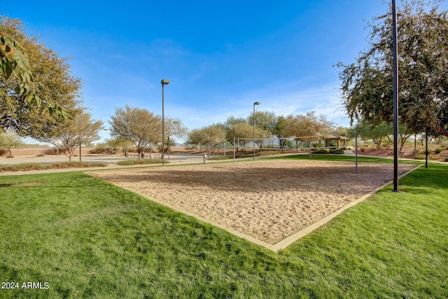 view of property's community featuring volleyball court and a yard