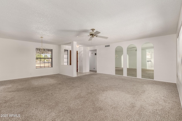 9857 W Tonto Ln, Peoria, AZ 85382 - carpeted empty room with a textured ceiling, a ceiling fan, and a chandelier