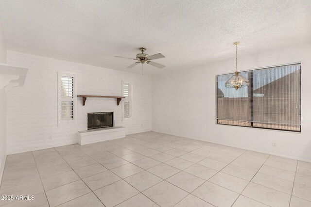 9857 W Tonto Ln, Peoria, AZ 85382 - unfurnished living room featuring a textured ceiling, a brick fireplace, a chandelier, a ceiling fan, and light tile patterned floors