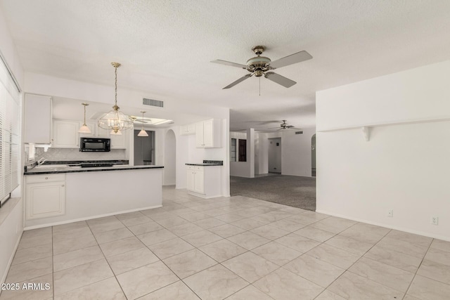 9857 W Tonto Ln, Peoria, AZ 85382 - kitchen with open floor plan, black microwave, ceiling fan, dark countertops, and a peninsula
