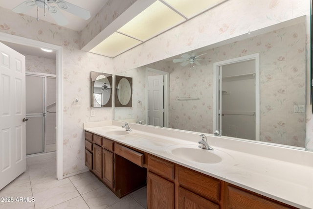 9857 W Tonto Ln, Peoria, AZ 85382 - full bath with ceiling fan, double vanity, a shower stall, tile patterned floors, and wallpapered walls