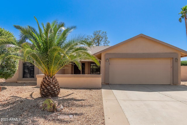 9857 W Tonto Ln, Peoria, AZ 85382 - view of front of property featuring stucco siding, a garage, and driveway