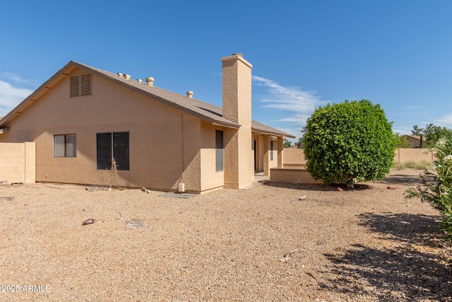 9857 W Tonto Ln, Peoria, AZ 85382 - rear view of house with a chimney and stucco siding
