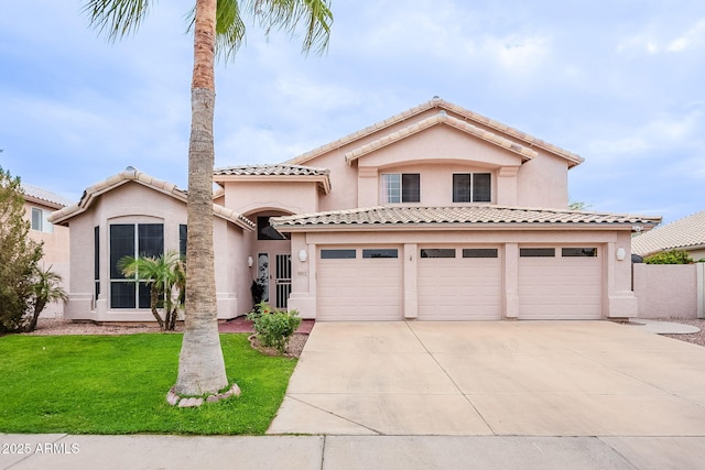 901 W Beck Ln, Phoenix, AZ 85023 - mediterranean / spanish-style house featuring concrete driveway, stucco siding, a tiled roof, a front yard, and a garage