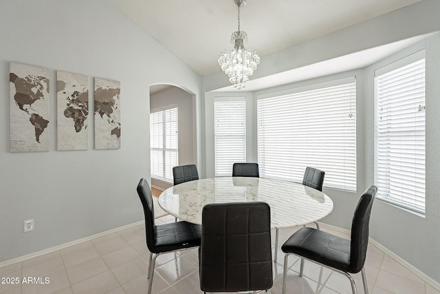 901 W Beck Ln, Phoenix, AZ 85023 - dining space featuring vaulted ceiling, an inviting chandelier, baseboards, light tile patterned flooring, and arched walkways