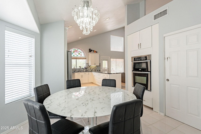 901 W Beck Ln, Phoenix, AZ 85023 - dining space featuring light tile patterned flooring, baseboards, visible vents, and a notable chandelier