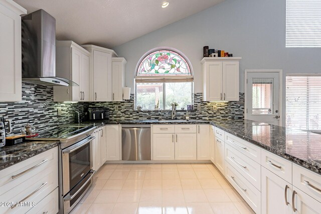 901 W Beck Ln, Phoenix, AZ 85023 - kitchen featuring wall chimney exhaust hood, lofted ceiling, stainless steel appliances, and white cabinets