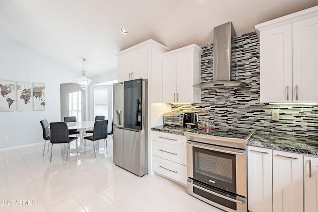 901 W Beck Ln, Phoenix, AZ 85023 - kitchen featuring a chandelier, wall chimney exhaust hood, appliances with stainless steel finishes, lofted ceiling, and decorative backsplash
