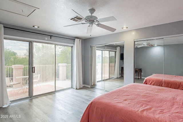 901 W Beck Ln, Phoenix, AZ 85023 - bedroom featuring a textured ceiling, visible vents, light wood finished floors, access to outside, and attic access