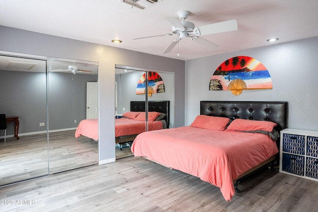 901 W Beck Ln, Phoenix, AZ 85023 - bedroom featuring multiple closets, visible vents, baseboards, wood finished floors, and a ceiling fan
