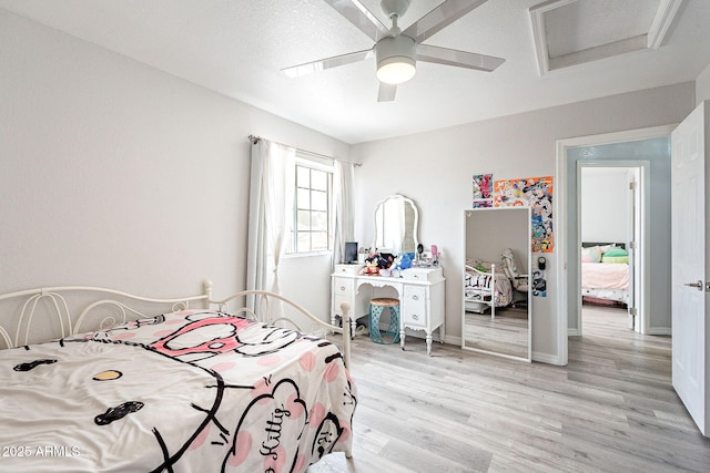 901 W Beck Ln, Phoenix, AZ 85023 - bedroom featuring attic access, baseboards, light wood-type flooring, and a ceiling fan