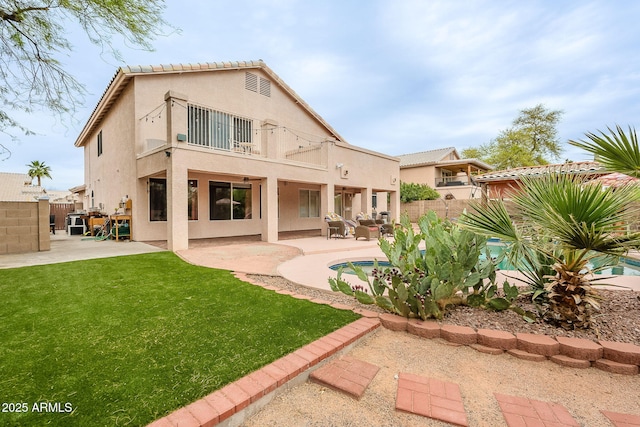 901 W Beck Ln, Phoenix, AZ 85023 - rear view of property featuring a patio area, stucco siding, a balcony, a fenced backyard, and a lawn