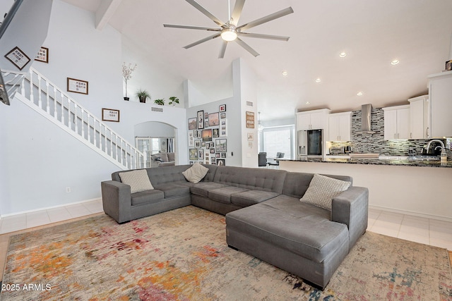 901 W Beck Ln, Phoenix, AZ 85023 - living room with stairway, light tile patterned floors, high vaulted ceiling, arched walkways, and a ceiling fan