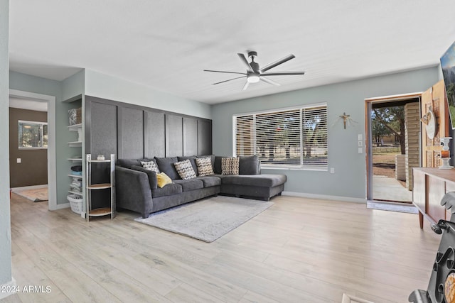 living room with light hardwood / wood-style flooring and ceiling fan