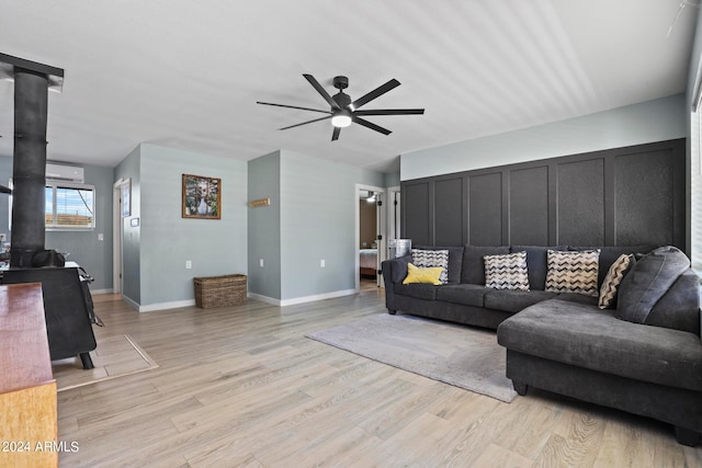 living room with ceiling fan and light hardwood / wood-style floors