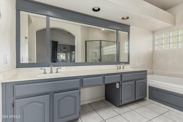 bathroom featuring vanity, tile patterned flooring, and plus walk in shower